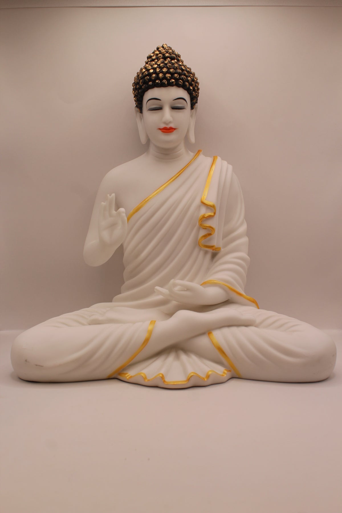 Matte white resin Buddha statue with gold trim, front