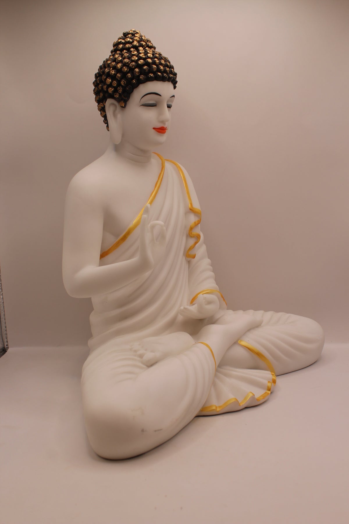 Matte white Buddha statue, left side