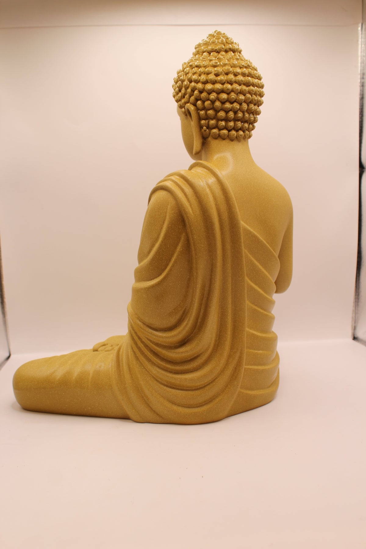 Mustard yellow Buddha statue, back