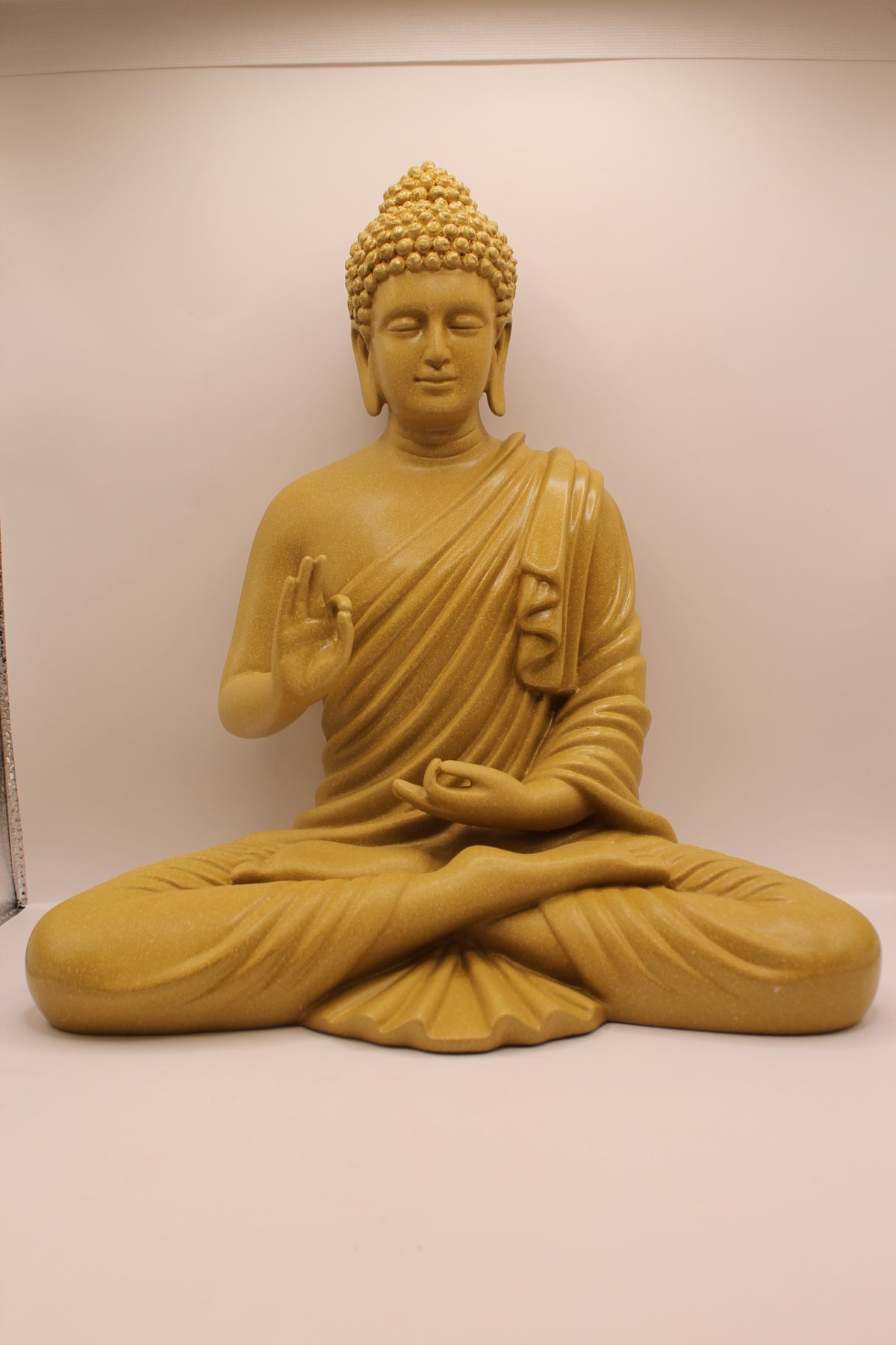 Mustard yellow resin Buddha statue, front