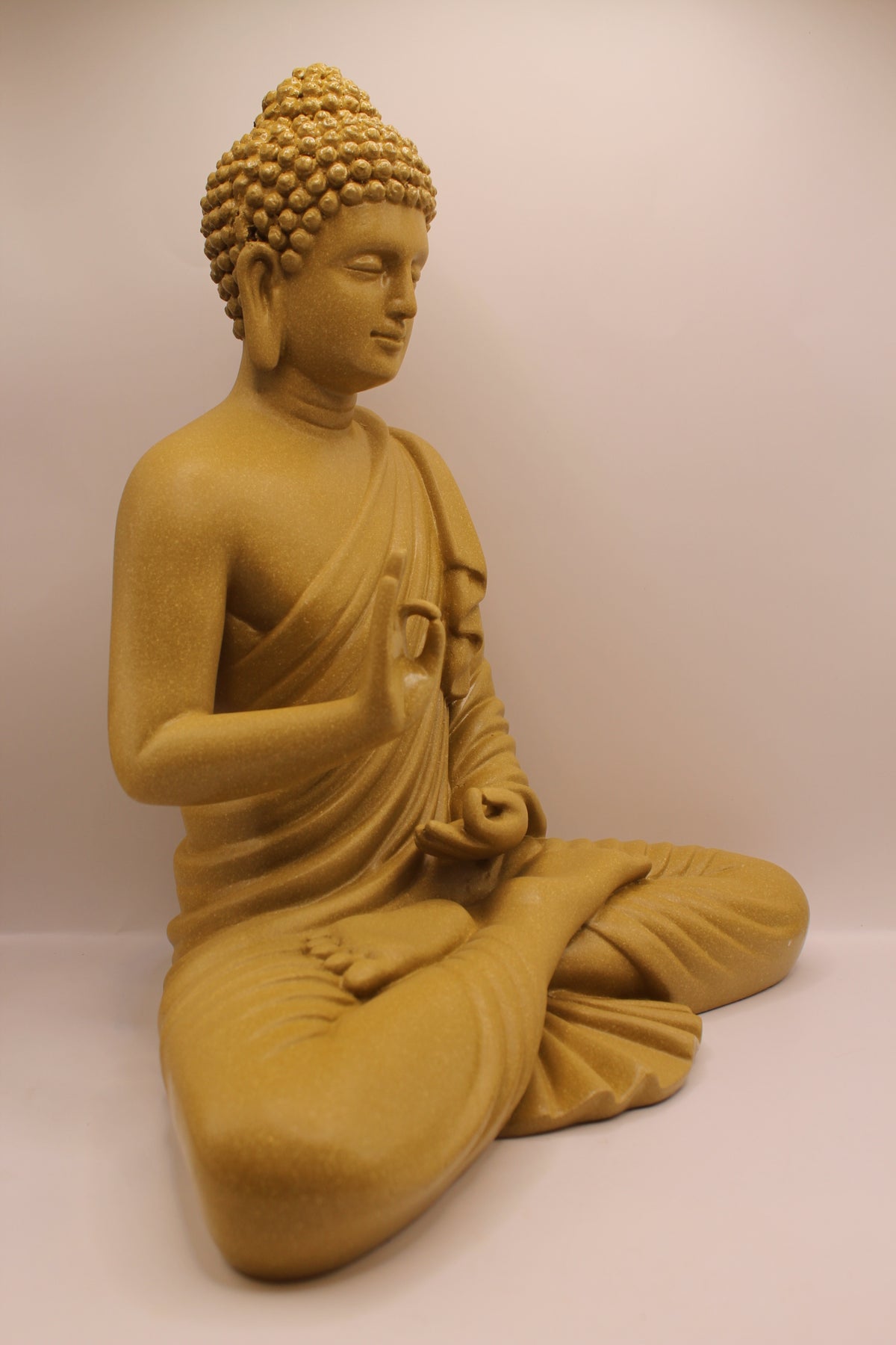 Mustard yellow Buddha statue, left side