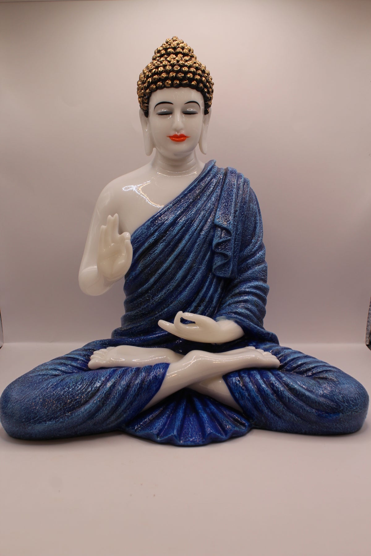 Resin Buddha statue with pastel blue robe, front