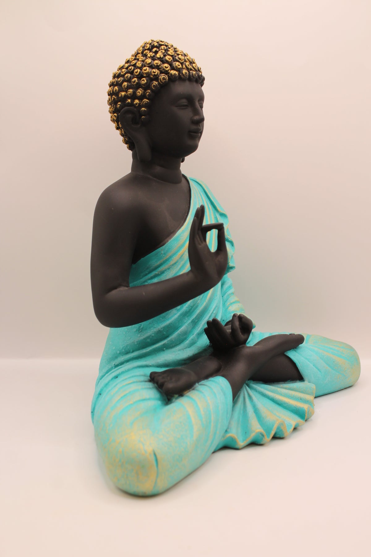 Sea blue and black Buddha statue, left side