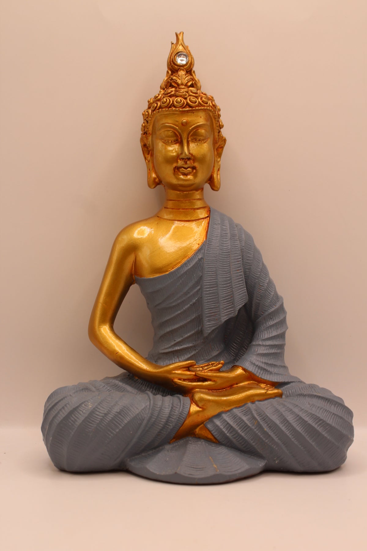 Small meditating Buddha statue, gold with slate grey robe, front