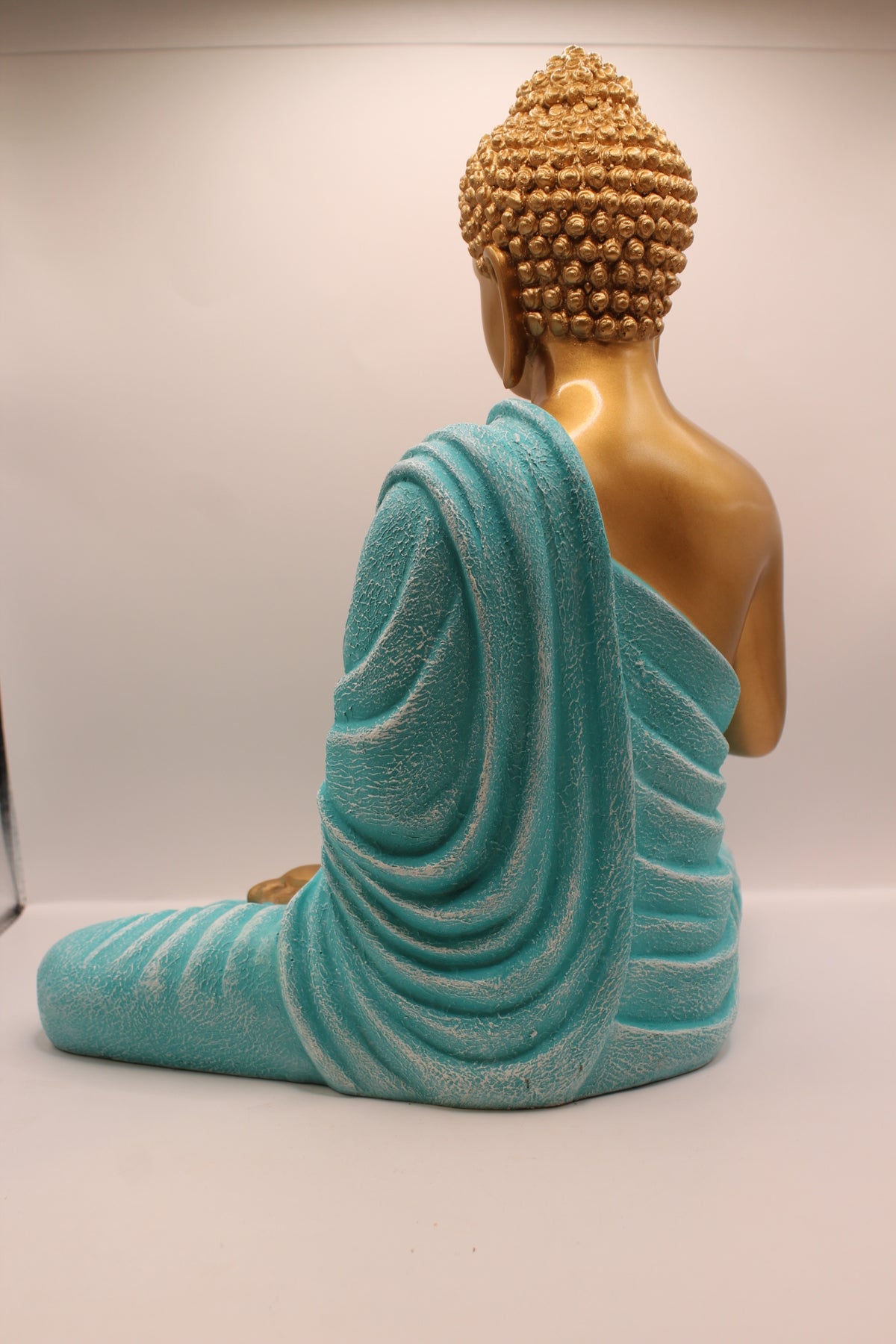 Turquoise and gold Buddha statue, back
