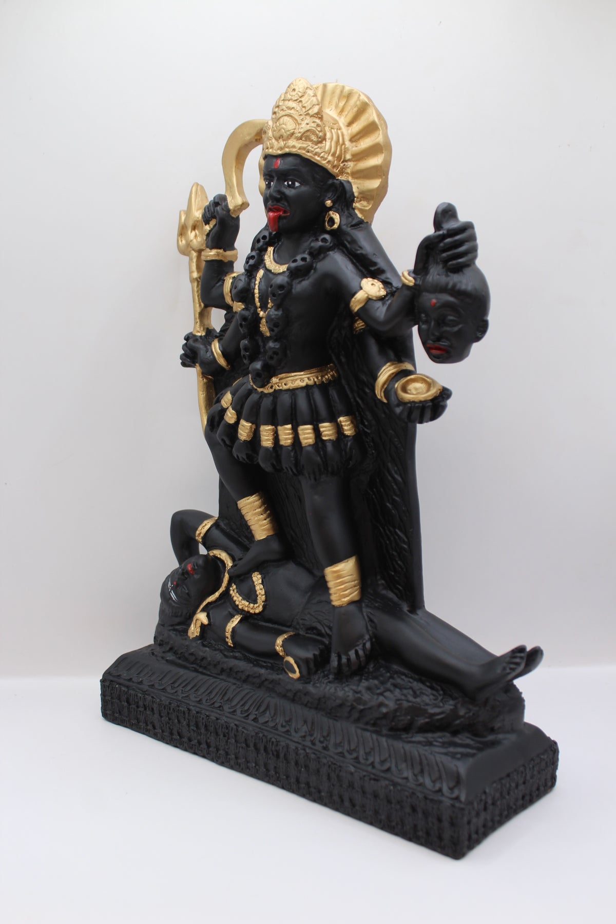 Resin Kali Mata statue, black and gold, standing, right side view