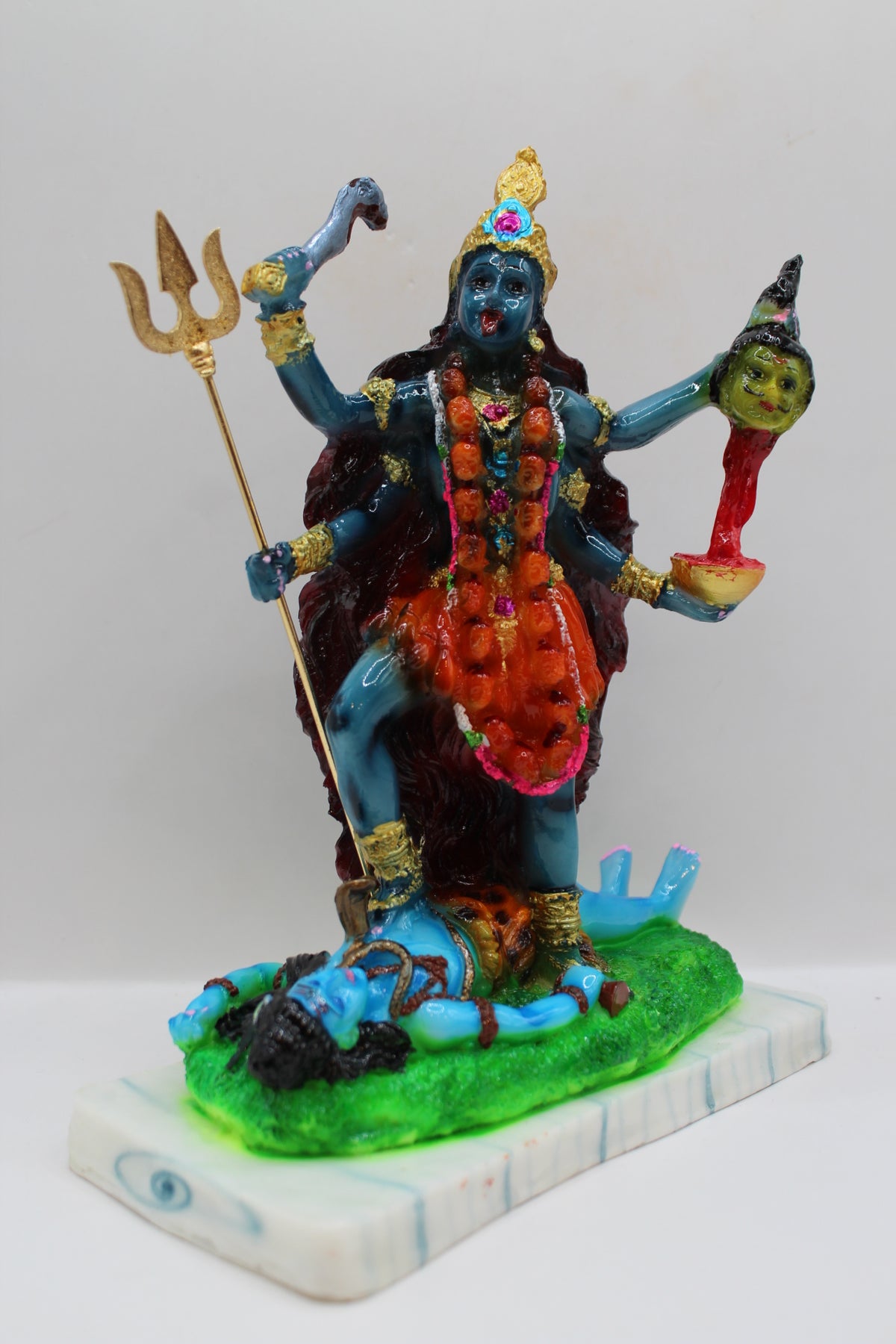 Resin Kali Mata statue, blue kali on green base, left side view