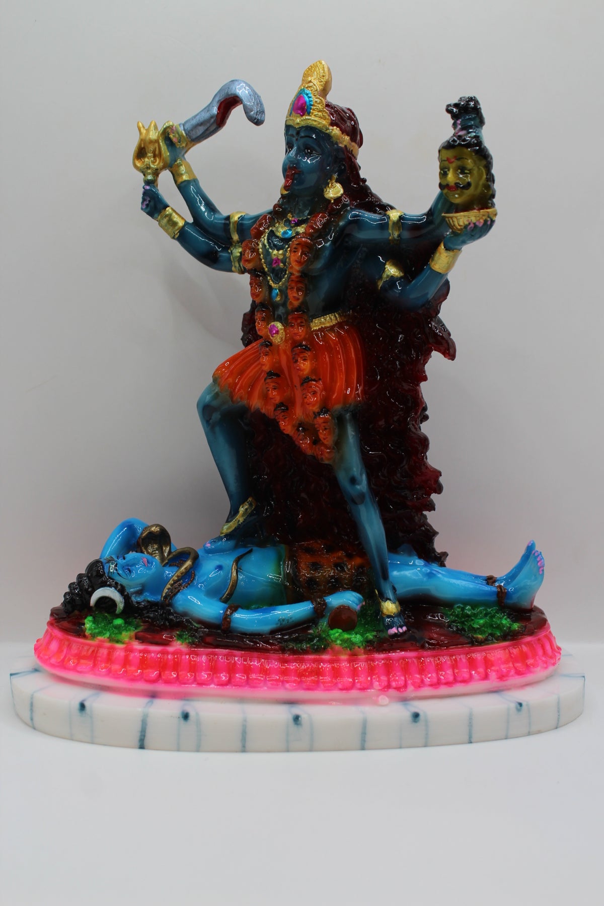 Resin Kali Mata statue, blue kali on pink base, front view