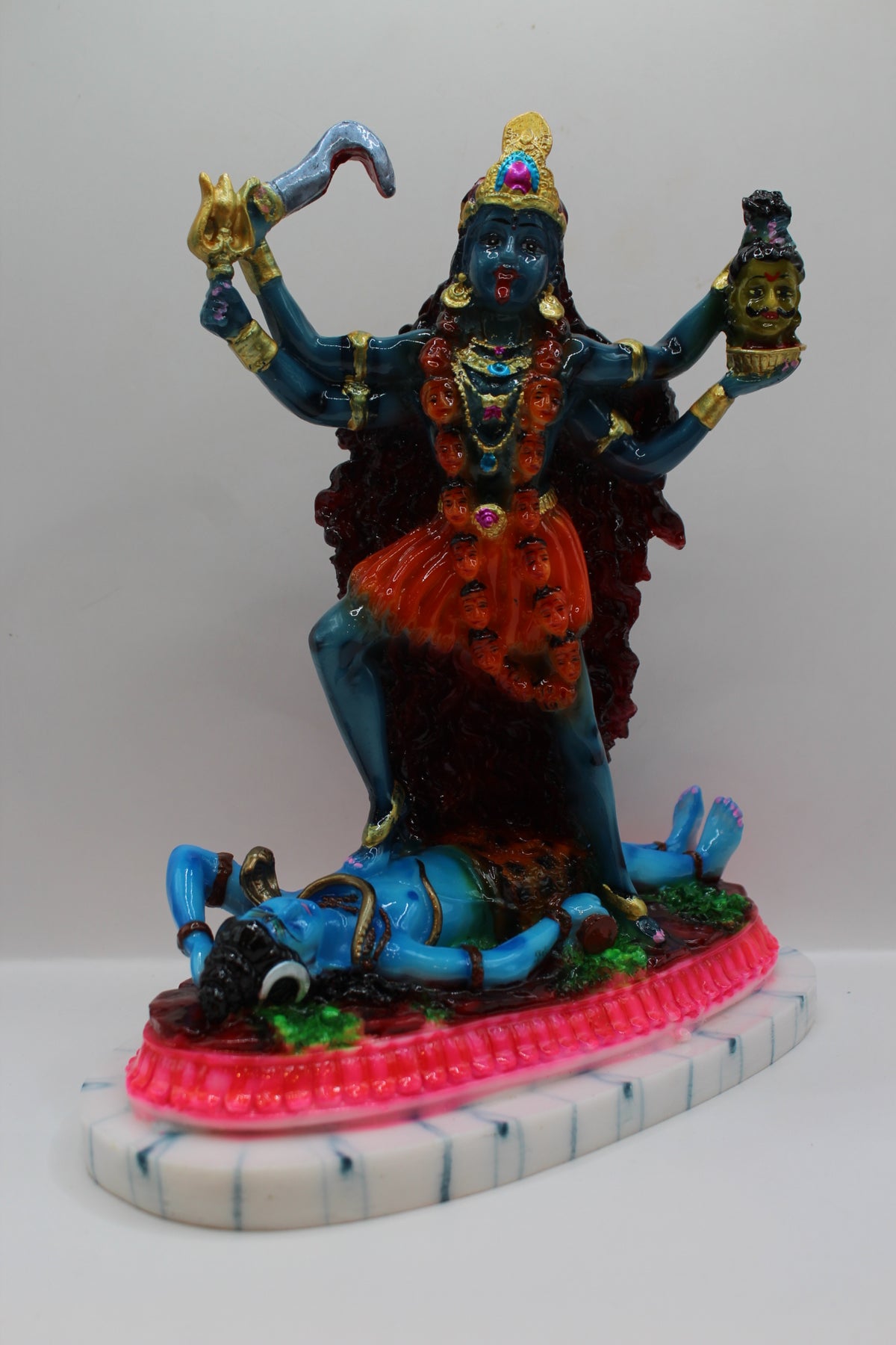 Resin Kali Mata statue, blue kali on pink base, left side view