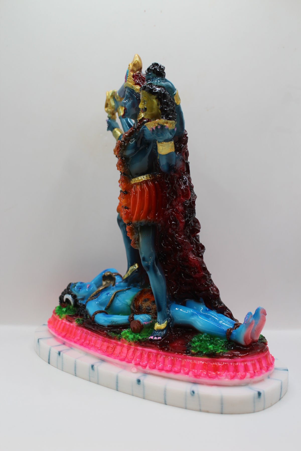 Resin Kali Mata statue, blue kali on pink base, right side view