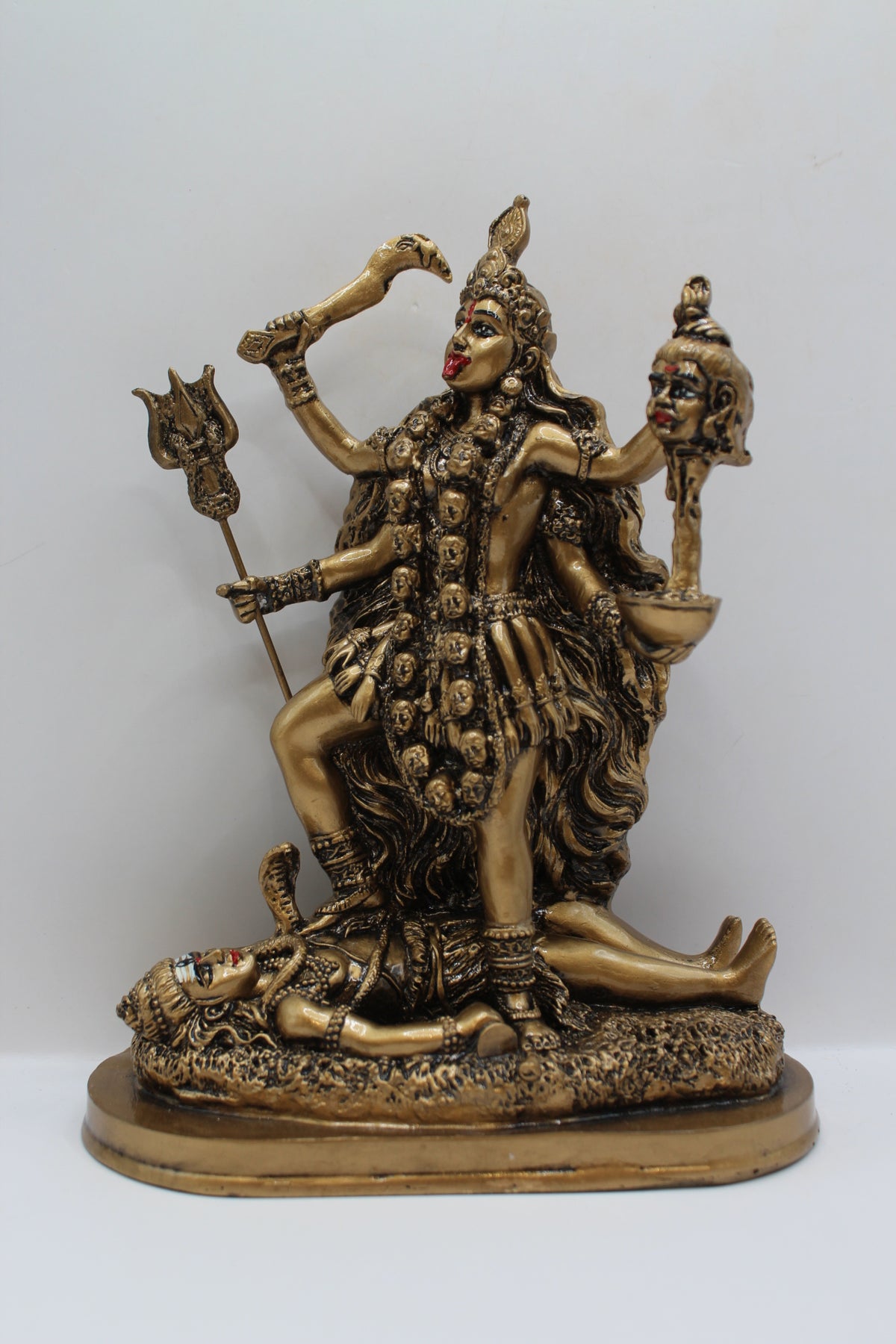 Resin Kali Mata statue, golden finish, front view