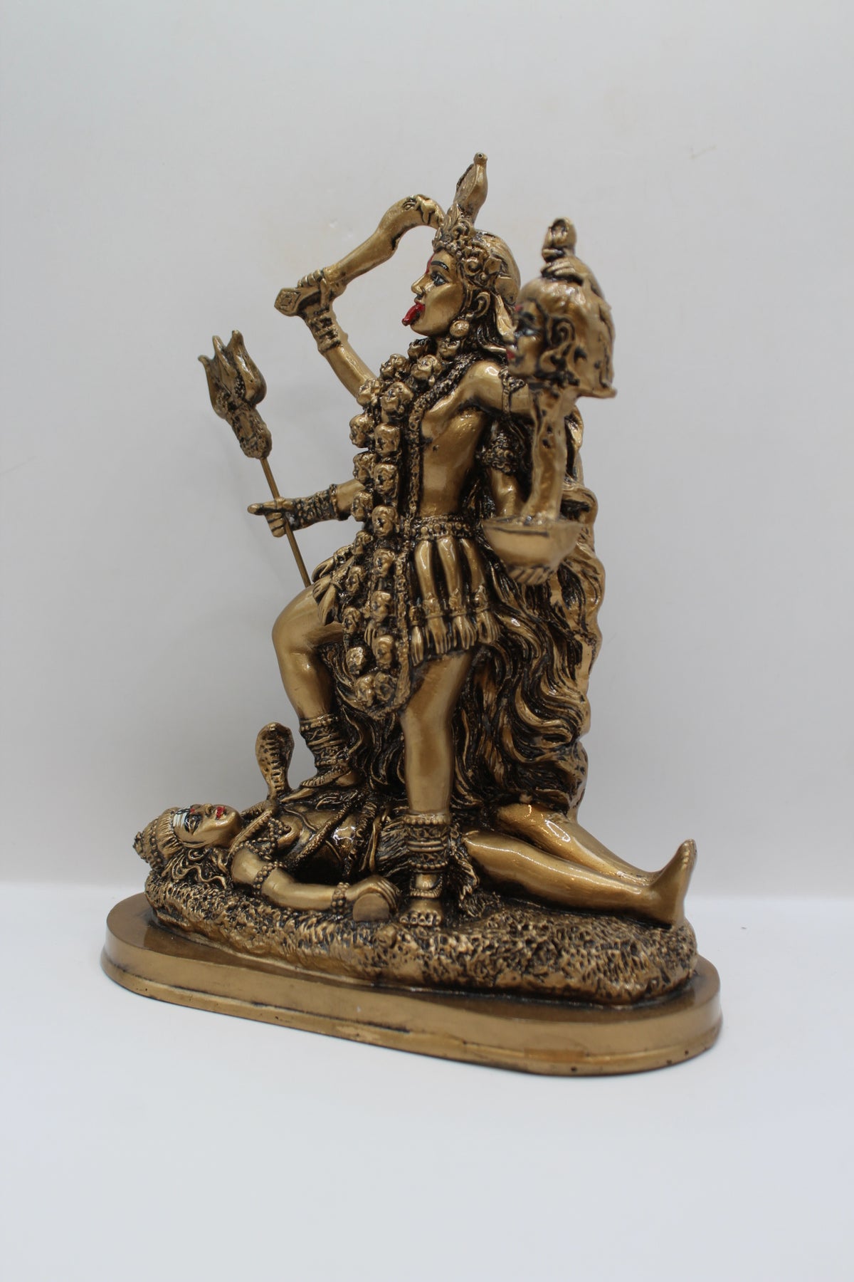 Resin Kali Mata statue, golden finish, right side view