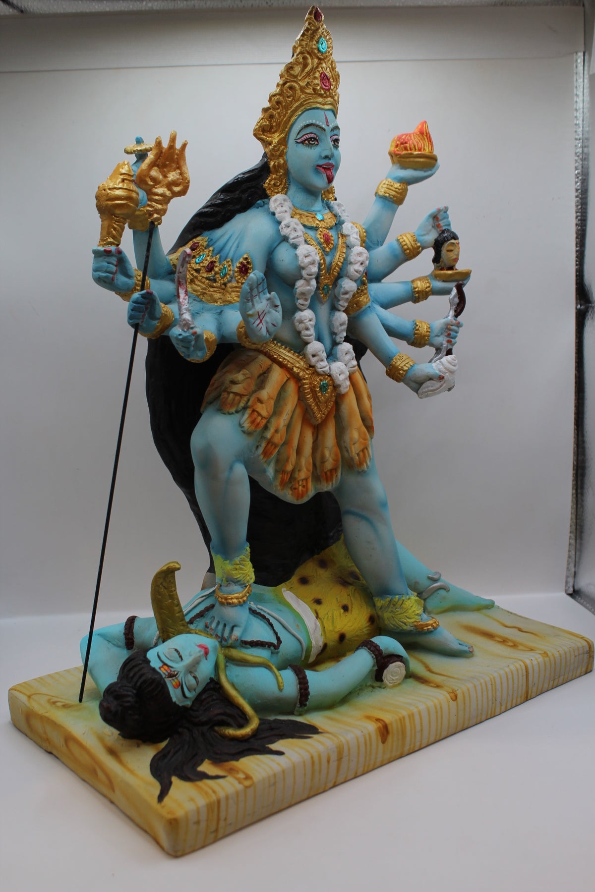 Resin Kali Mata statue, many arms, blue and gold, left side view