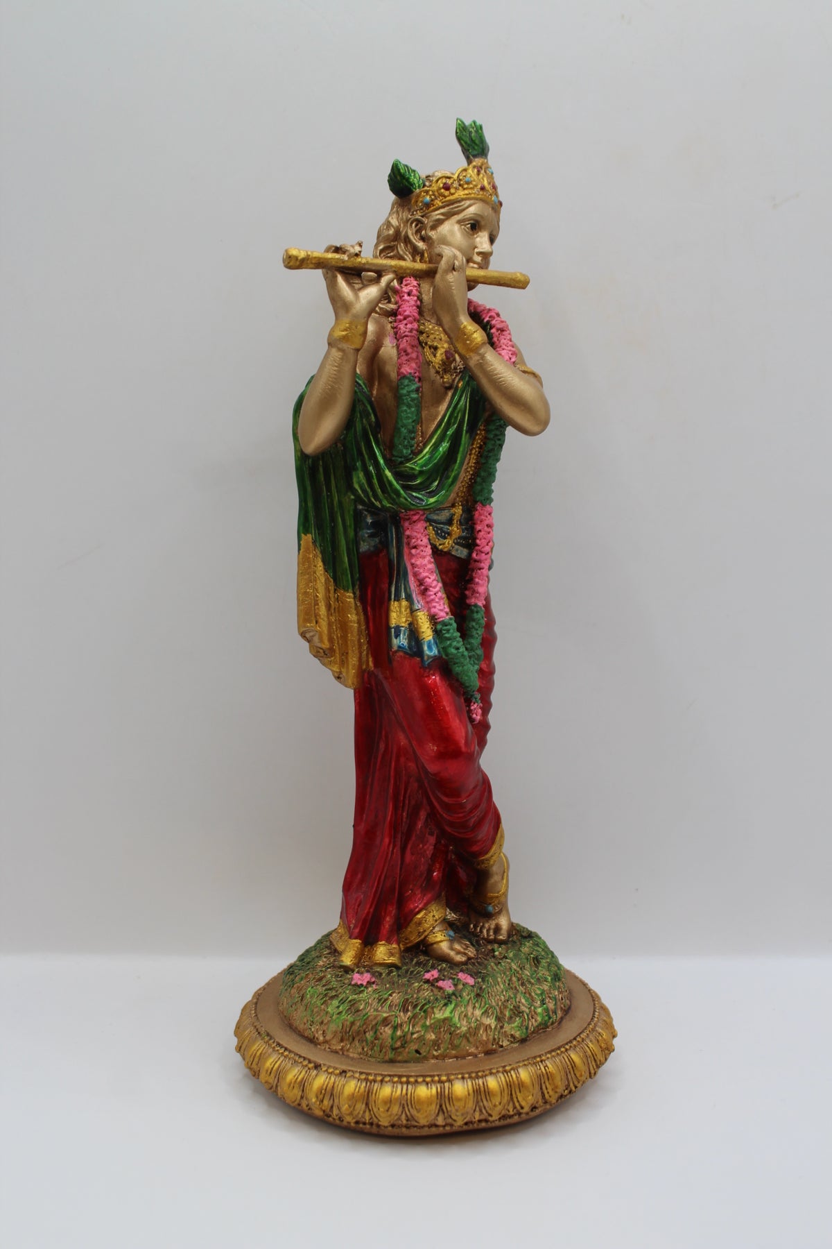 Resin Krishna statue, playing flute, antique bronze, left side view