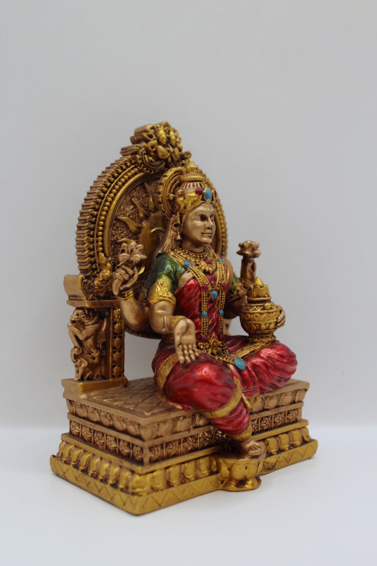Resin Laxmi statue, seated on throne, antique bronze, left side view