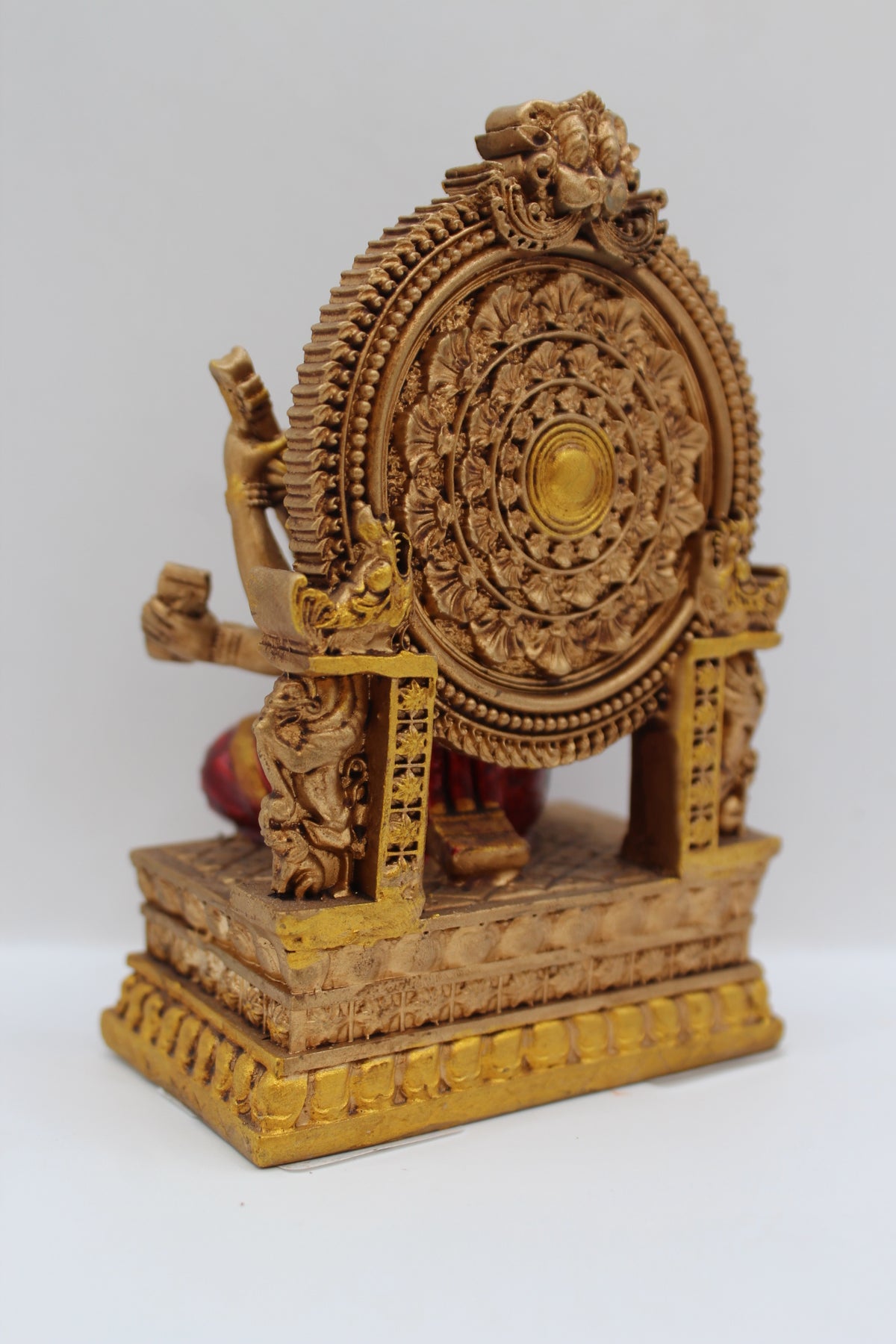 Resin Saraswati statue, seated on throne, antique bronze, back view
