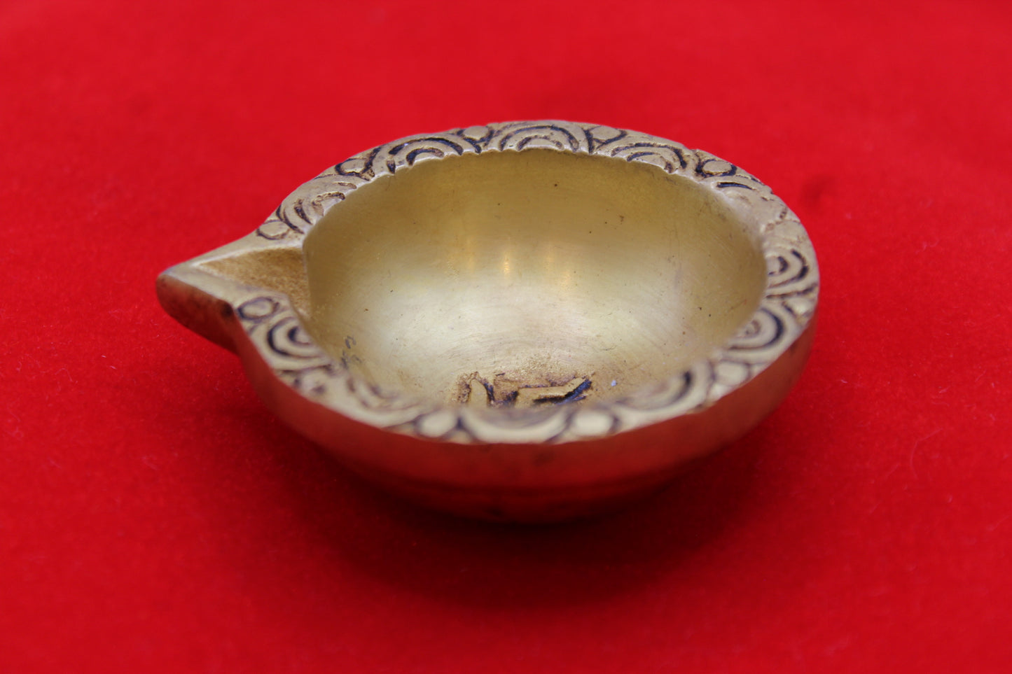 Brass diya, angled view showing the depth of the well