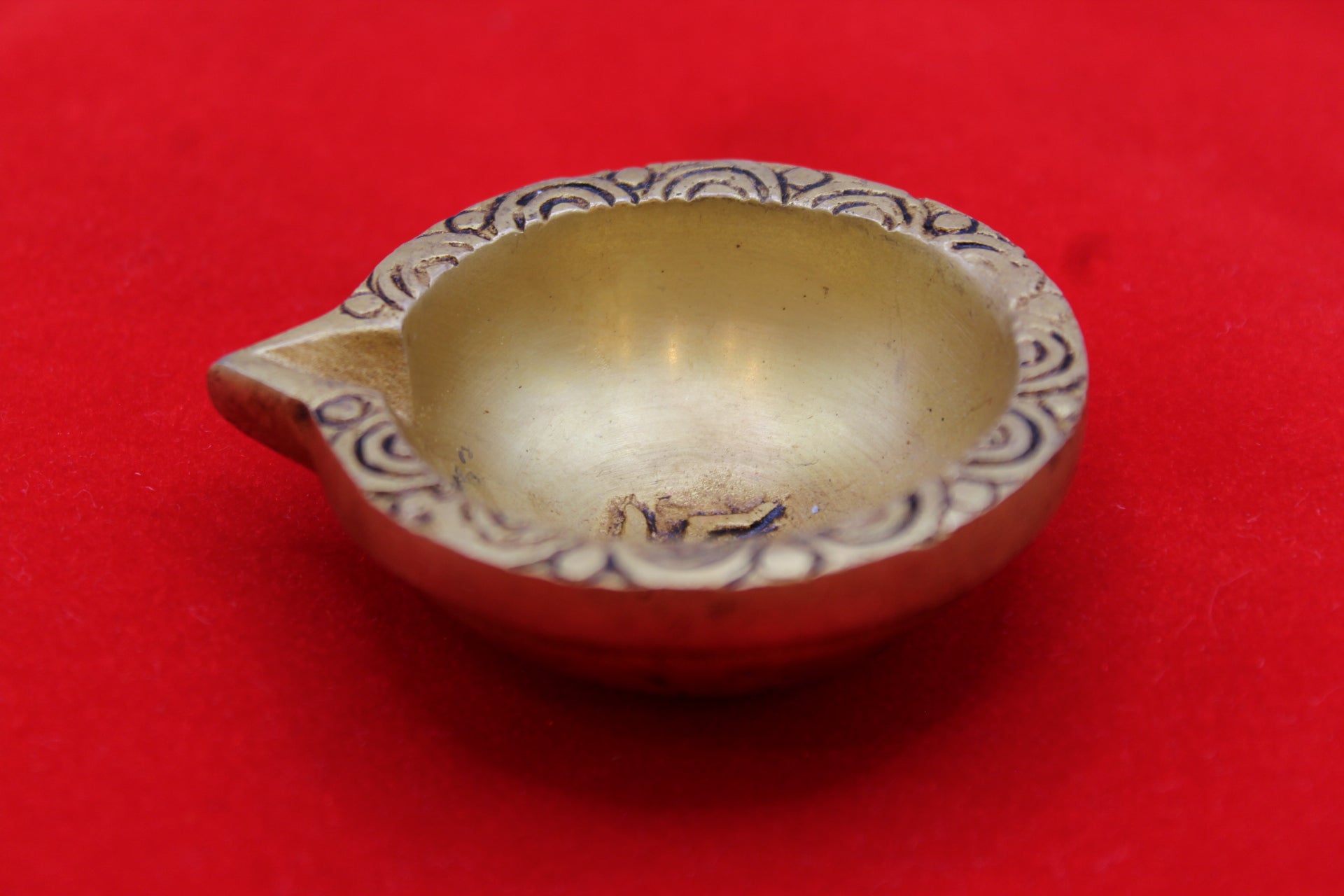 Brass diya, angled view showing the depth of the well
