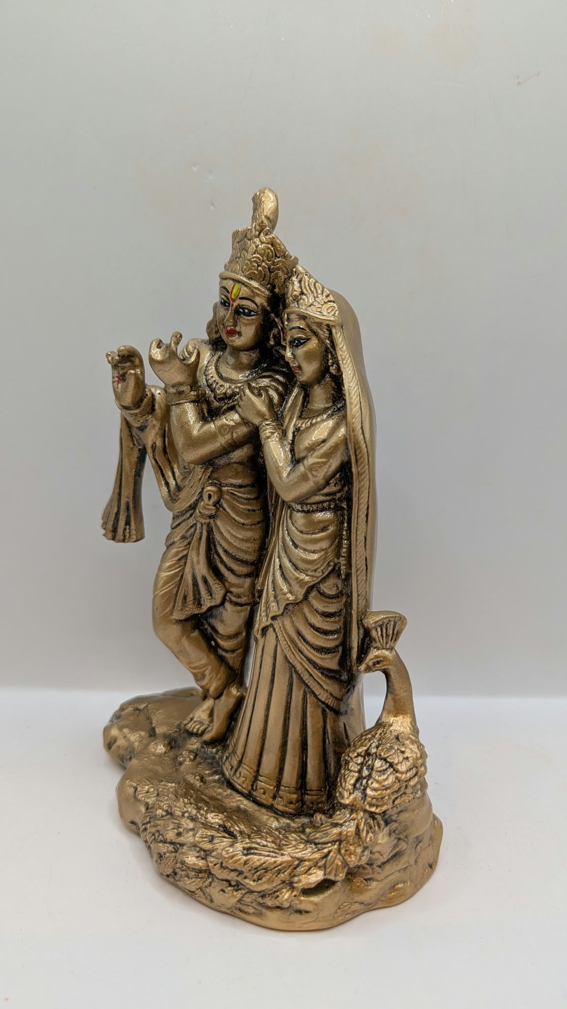 Radha Krishna statue in antique gold finish, side view