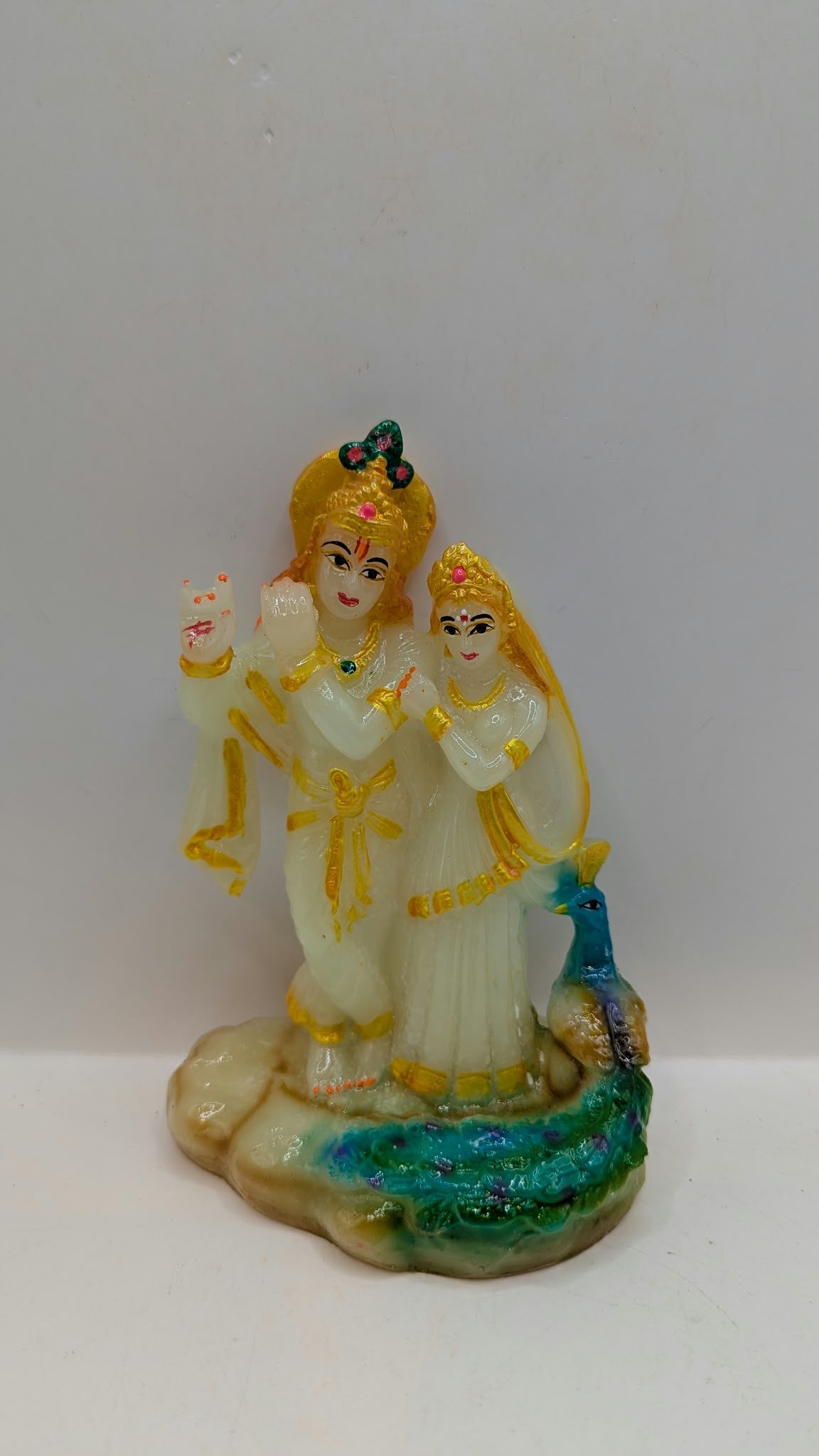 White and multicolour Radha Krishna statue, front view