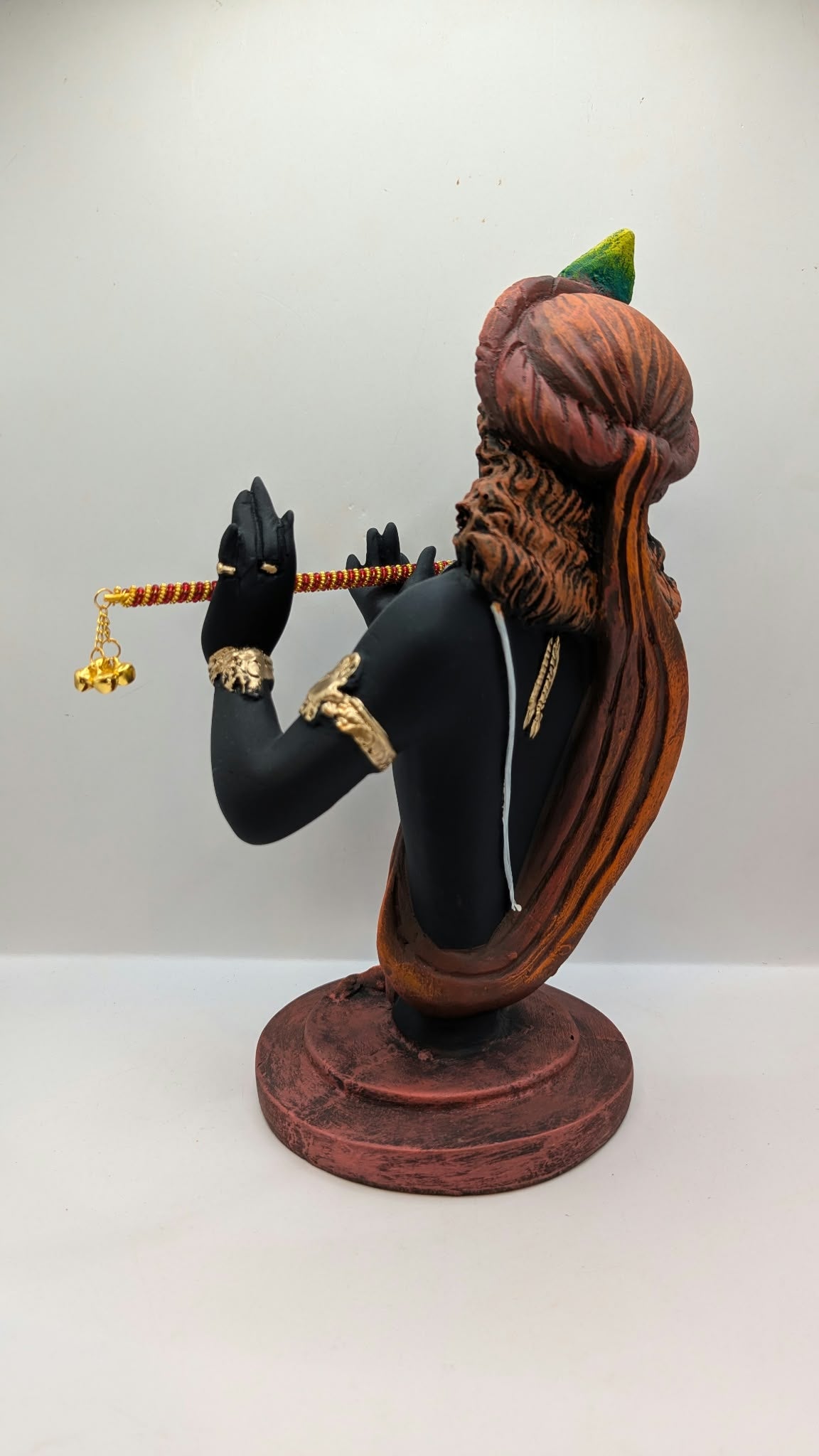 Black Lord Krishna bust statue with flute, back view