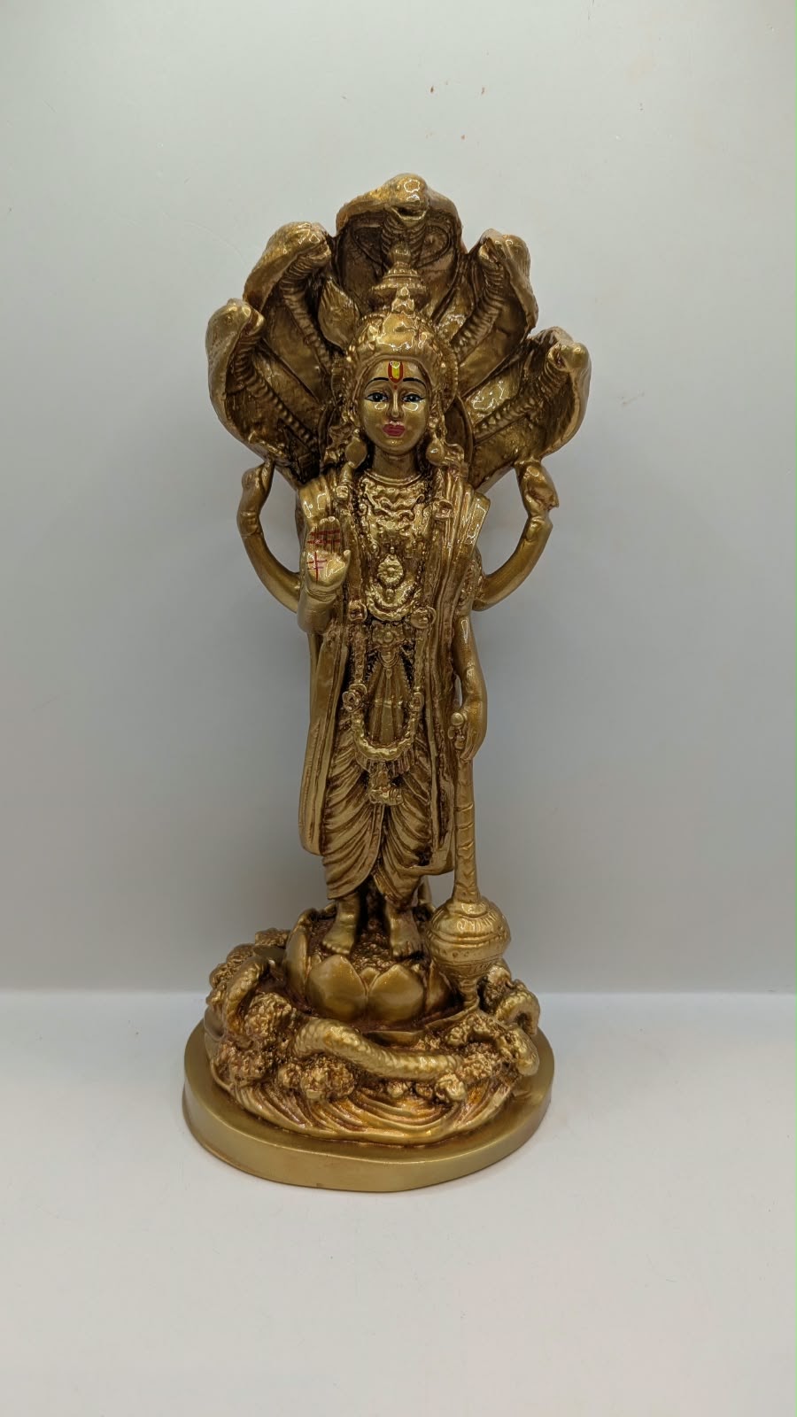 Gold Lord Vishnu statue with snake hood, front view