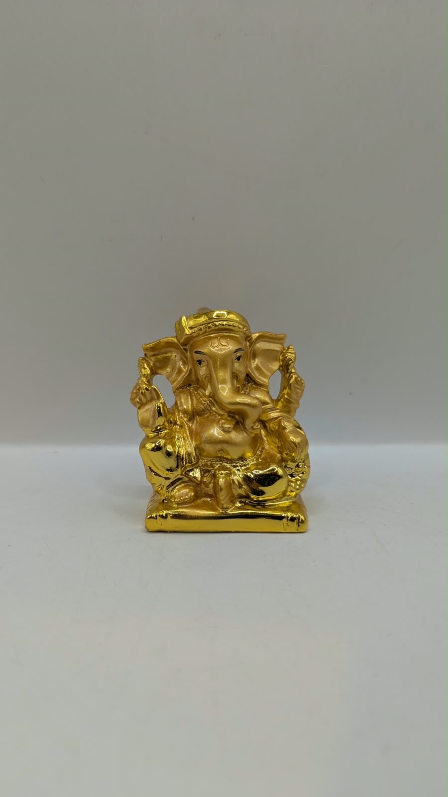 Small gold Ganesh statue, front view