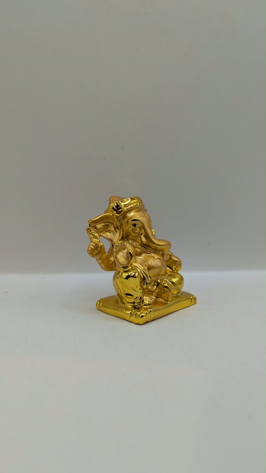 Small gold Ganesh statue, side view
