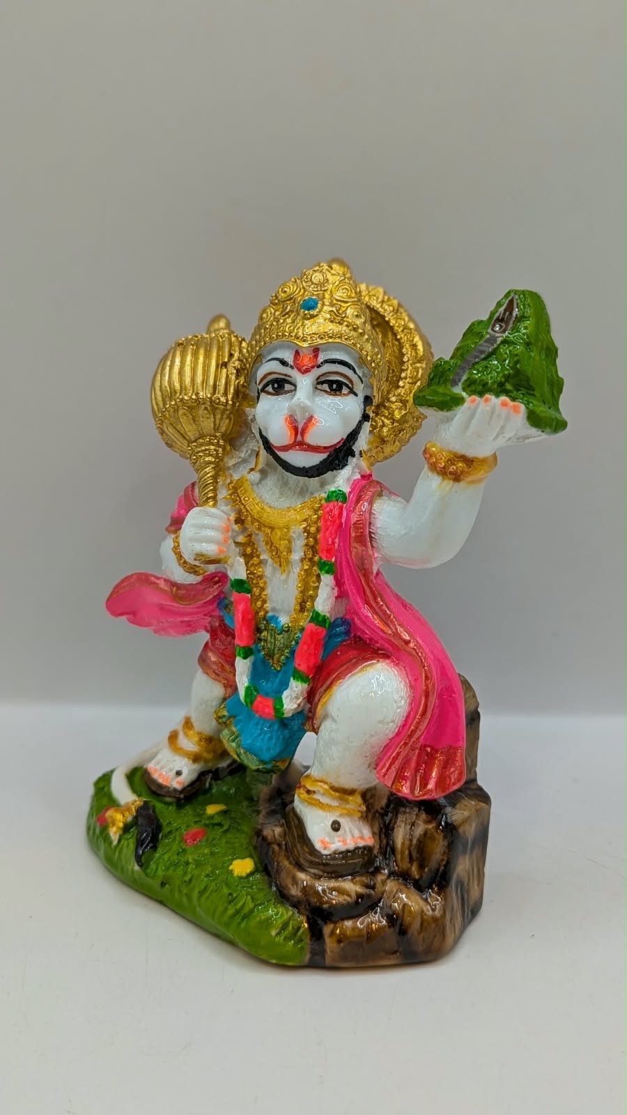 Colourful Hanuman statue with mountain and mace, other side view