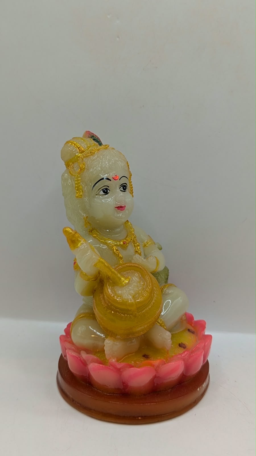 Laddu Gopal baby Krishna statue on pink lotus, front view