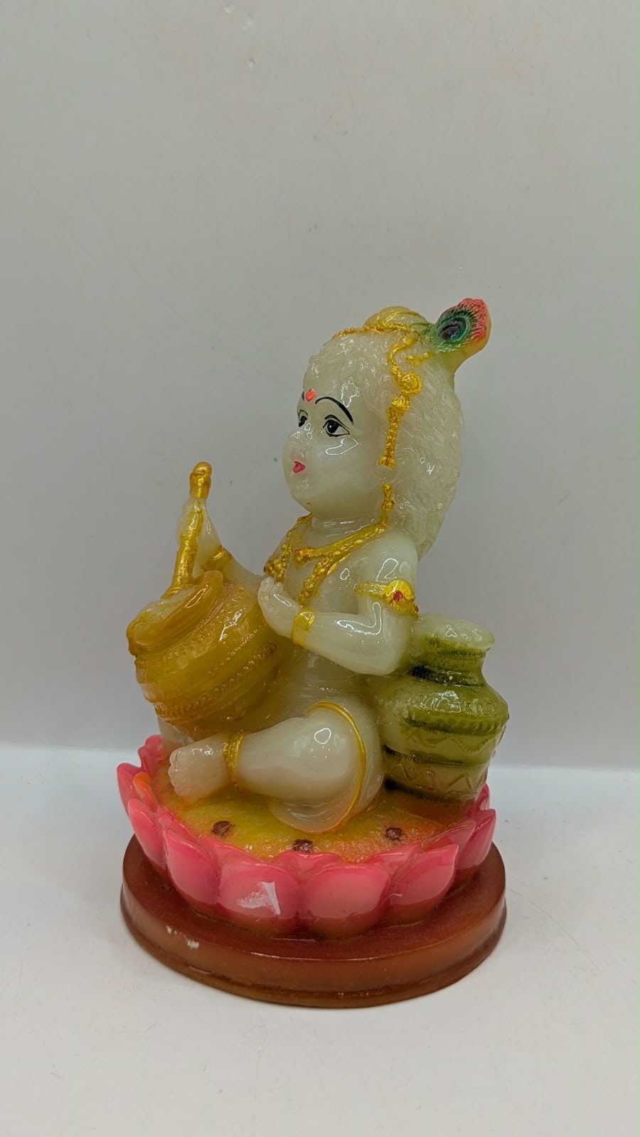 Laddu Gopal baby Krishna statue on pink lotus, side view