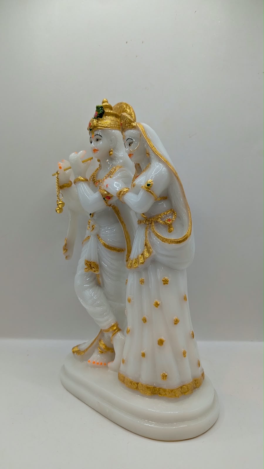 Tall white and gold Radha Krishna statue, other side view