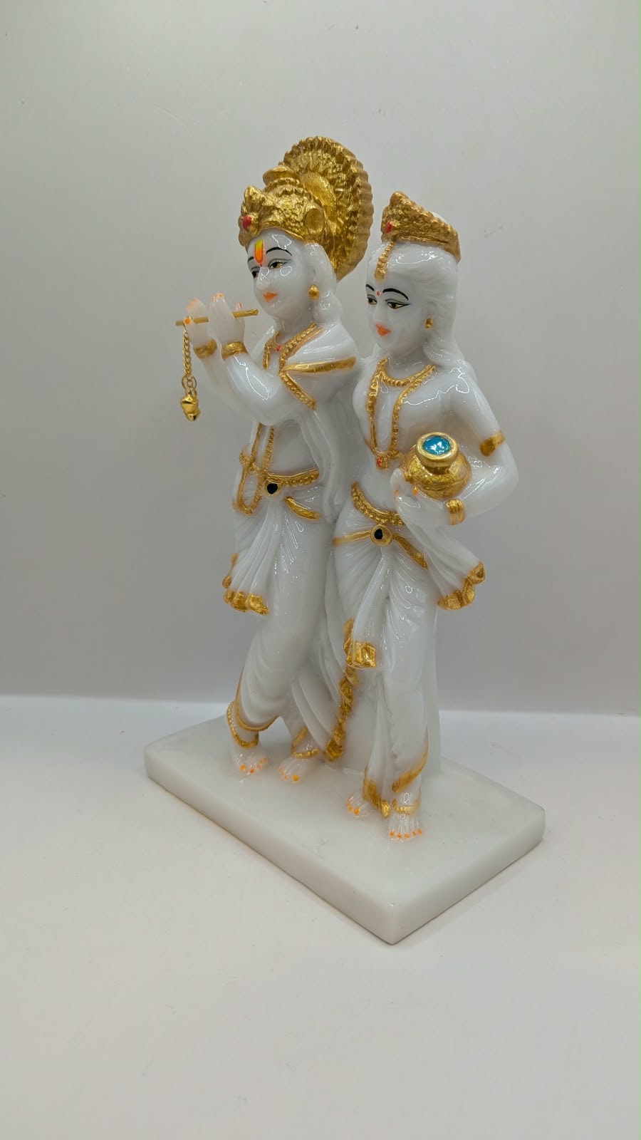 White and gold Radha Krishna statue with halo, other side view
