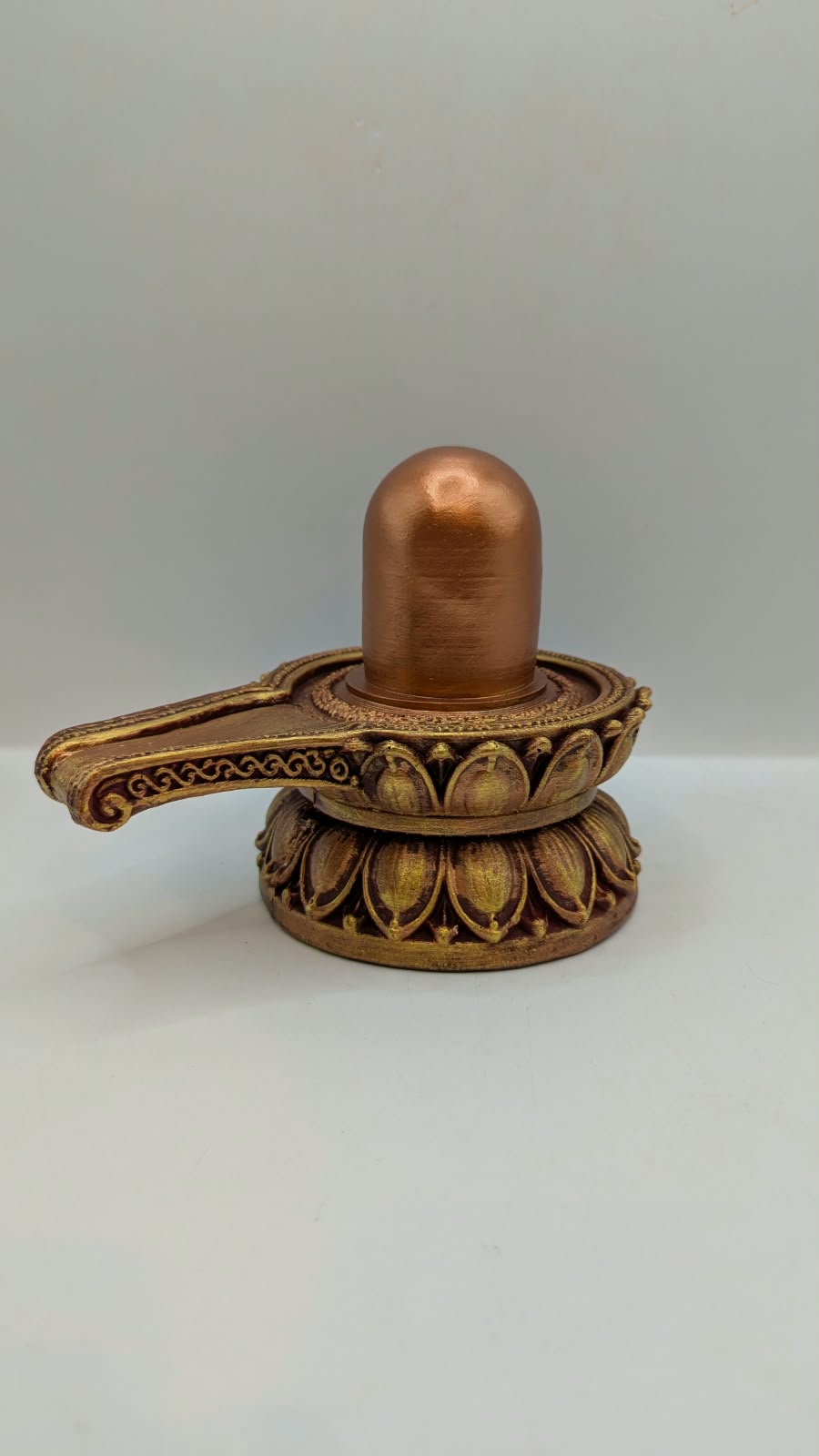 Copper and gold Shivling statue, back view