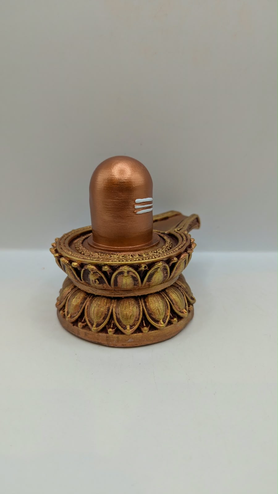 Small copper and gold Shivling statue, side view