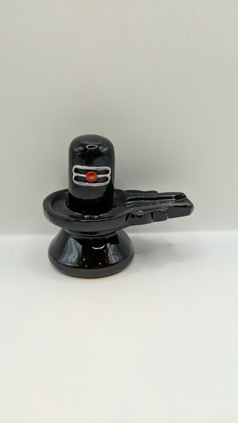 Glossy black Shivling statue, front view