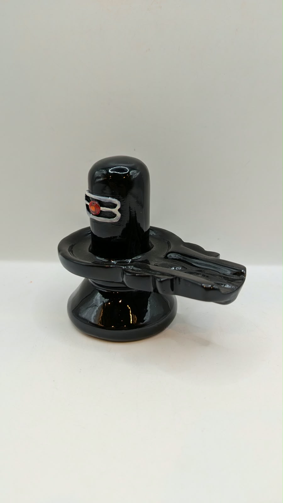Glossy black Shivling statue, other side view
