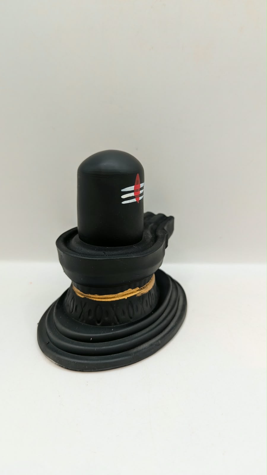 Matt black Shivling statue, side view