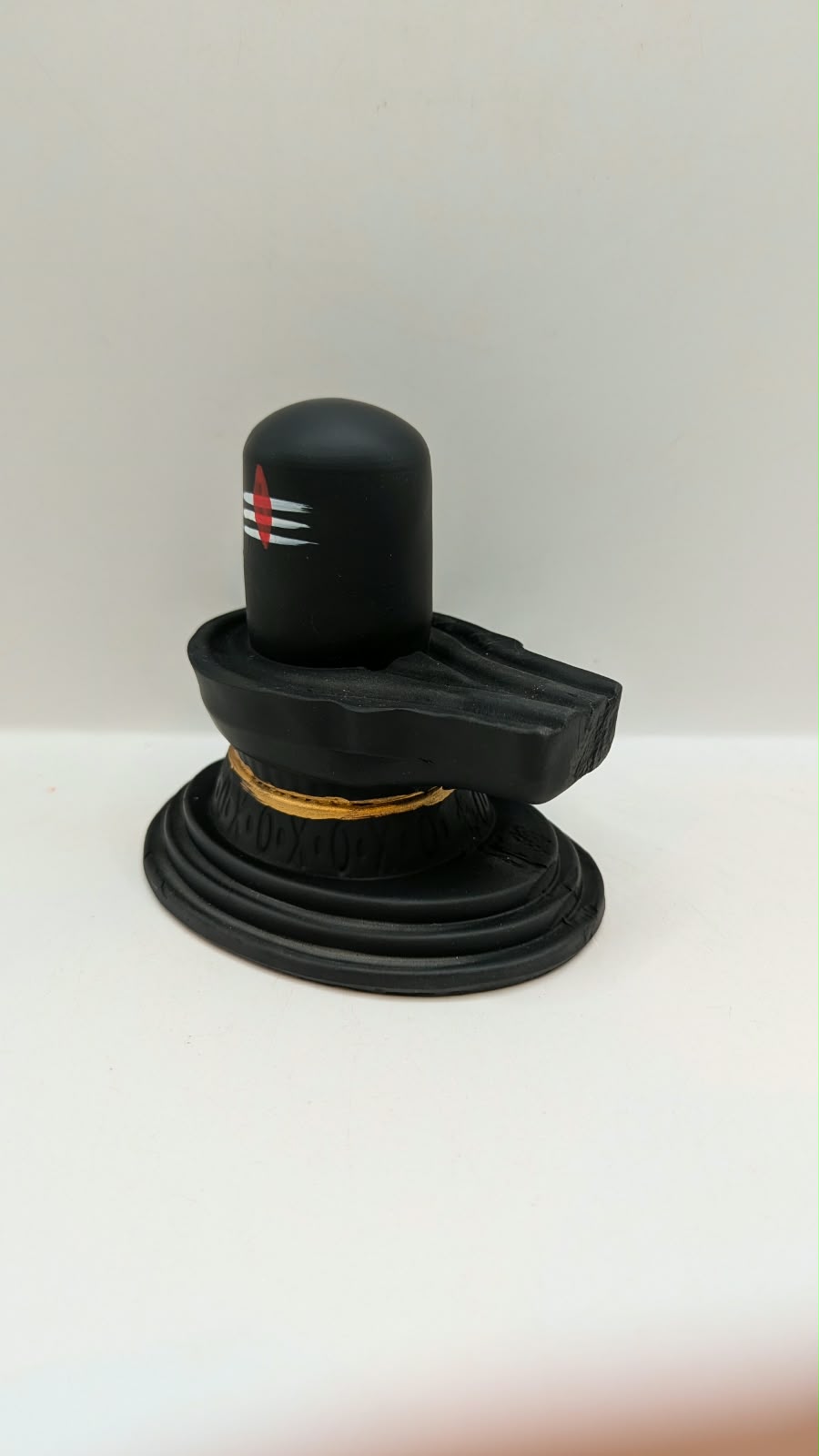 Matt black Shivling statue, other side view