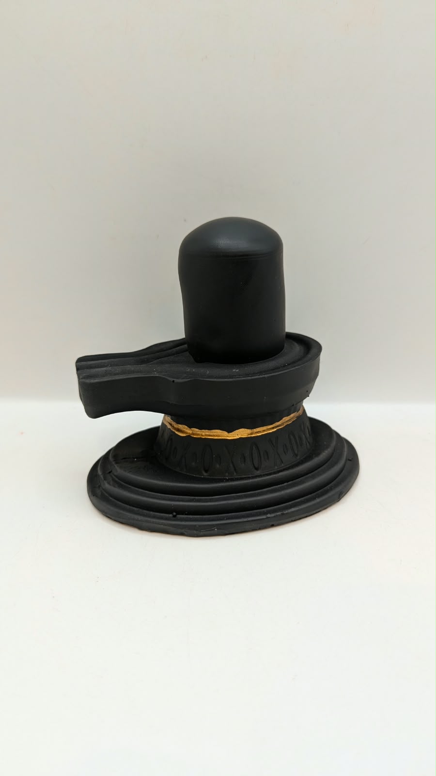 Matt black Shivling statue, back view
