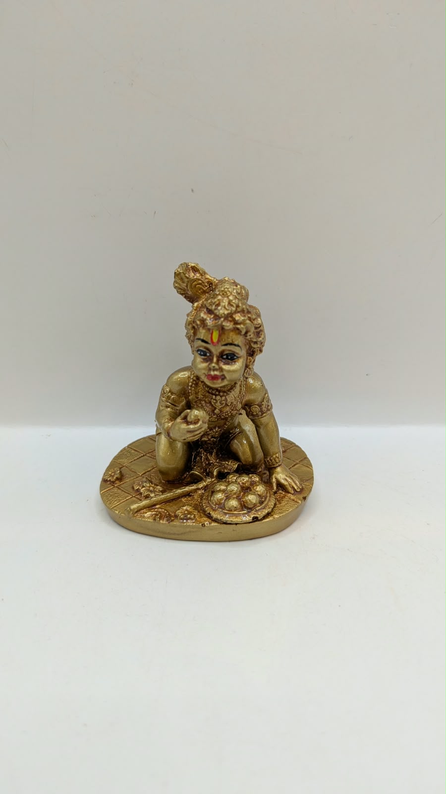 Gold crawling baby Krishna statue, front view