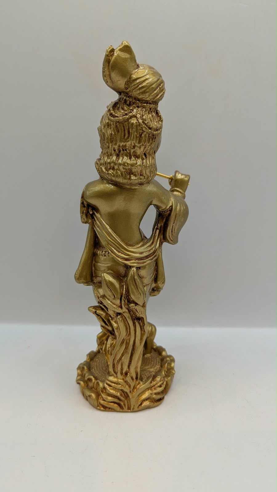 Gold standing Krishna statue with flute, back view