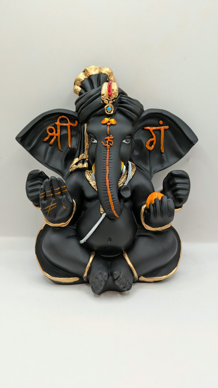 Black Ganesh statue with Shri on ears, front view