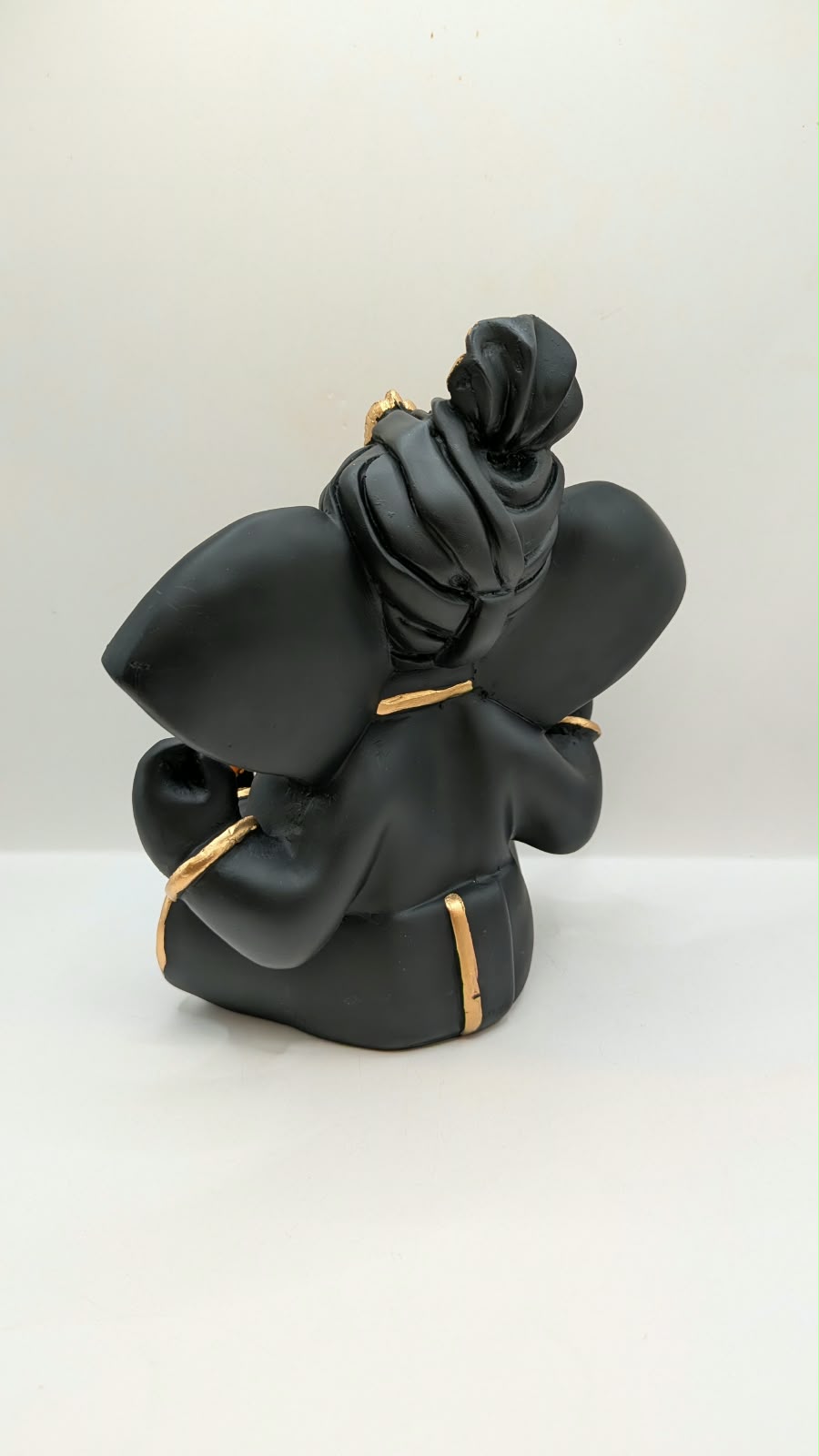Black Ganesh statue with Shri on ears, back view