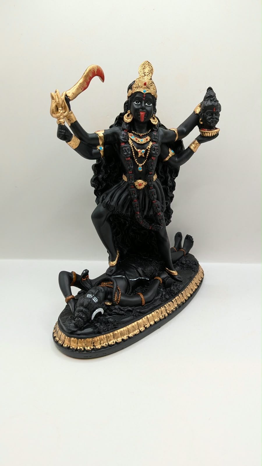 Black and gold Kali Maa statue, side view