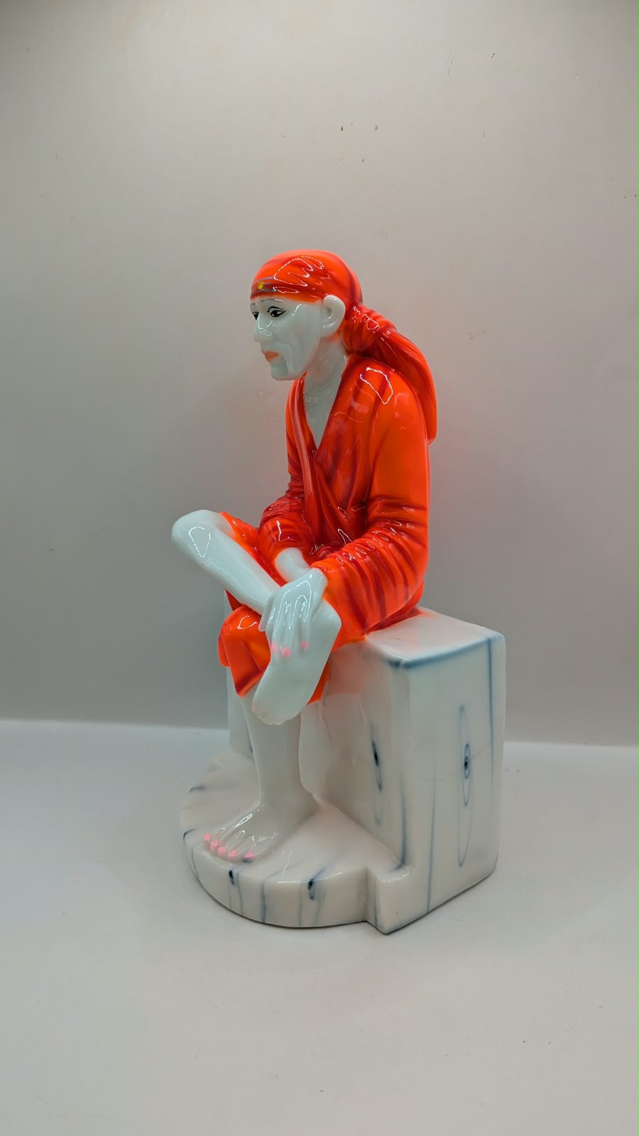 Sai Baba statue on white seat, other side view