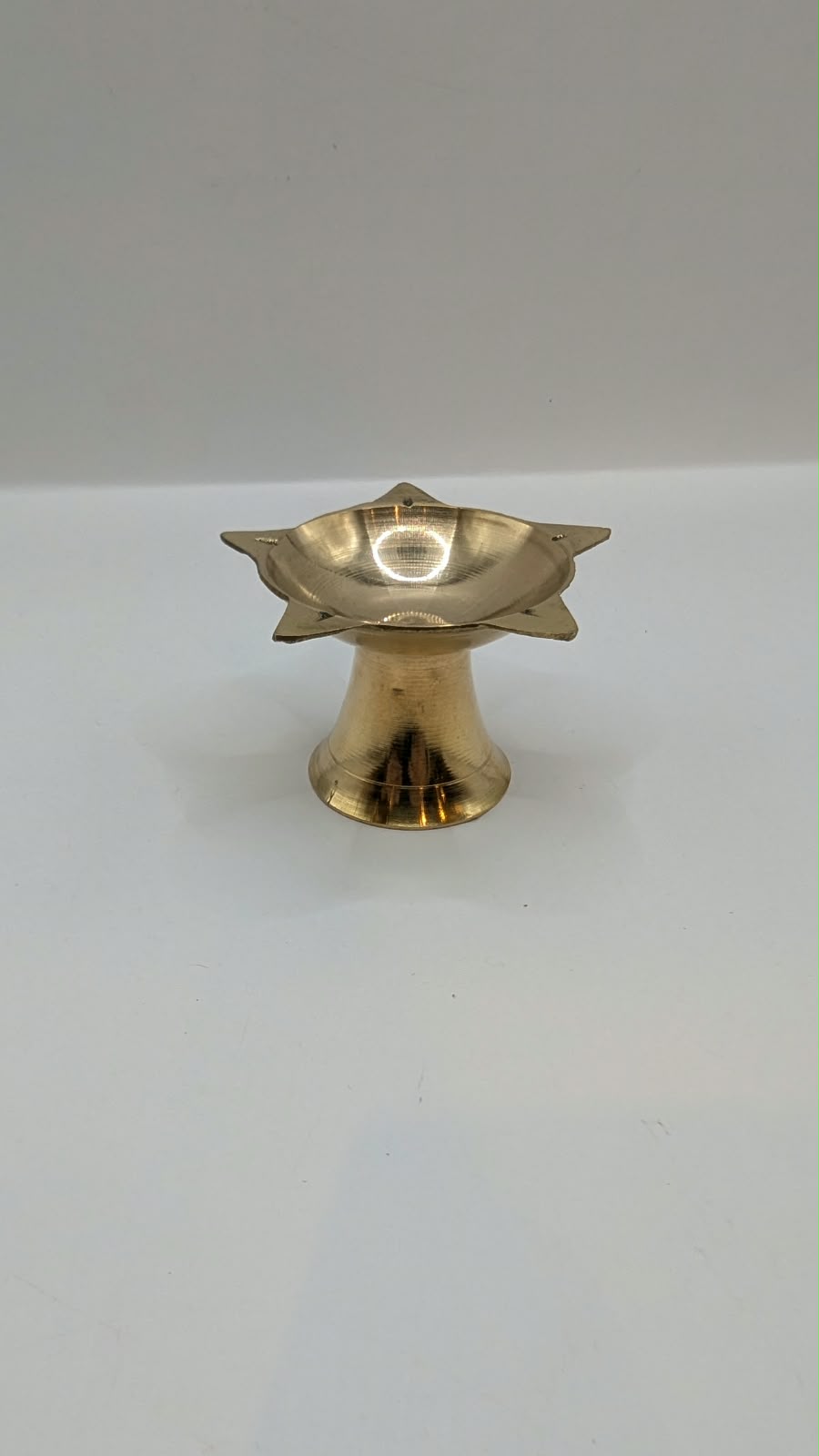 Metal star diya on stand, front view