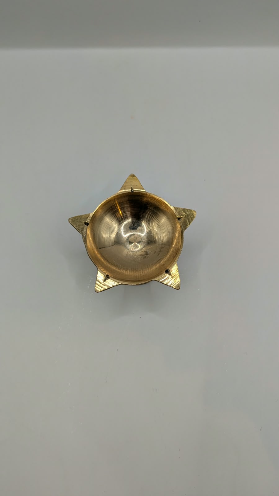 Metal star diya on stand, top view