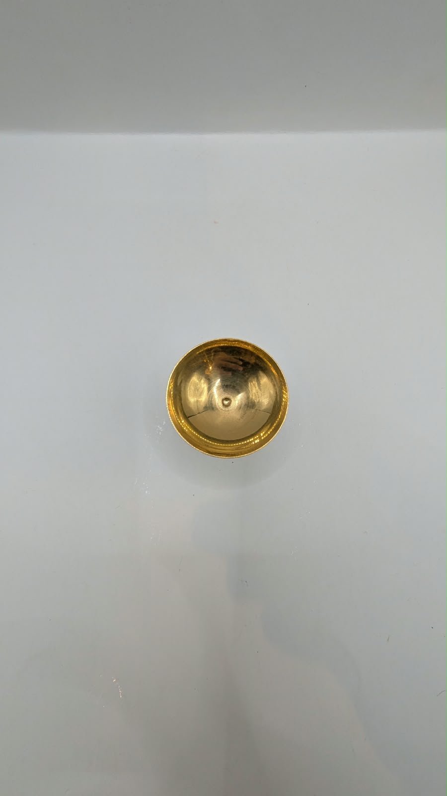 Metal diya on stand, front view