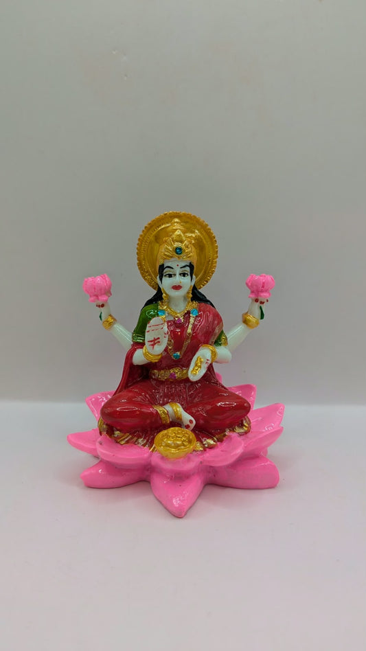 Laxmi statue in red saree on pink lotus, front view